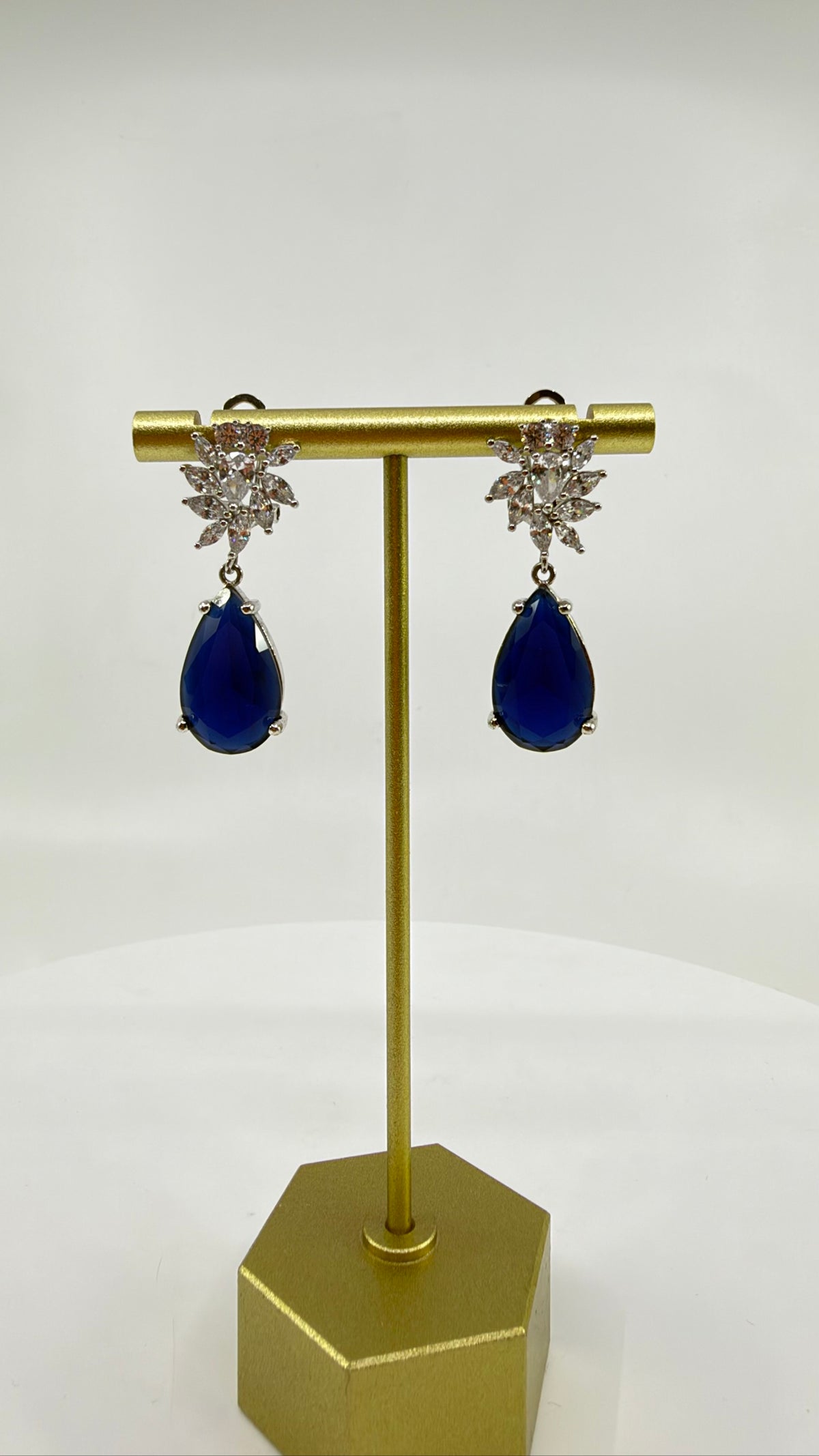 Sapphire Bloom Teardrop Earrings on stand