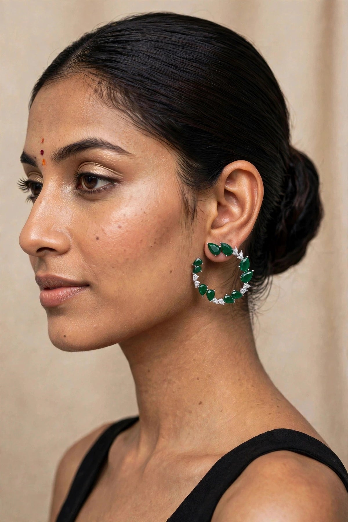 Model wearing Pear-Cut Crystal Hoop Earrings, Emerald Green