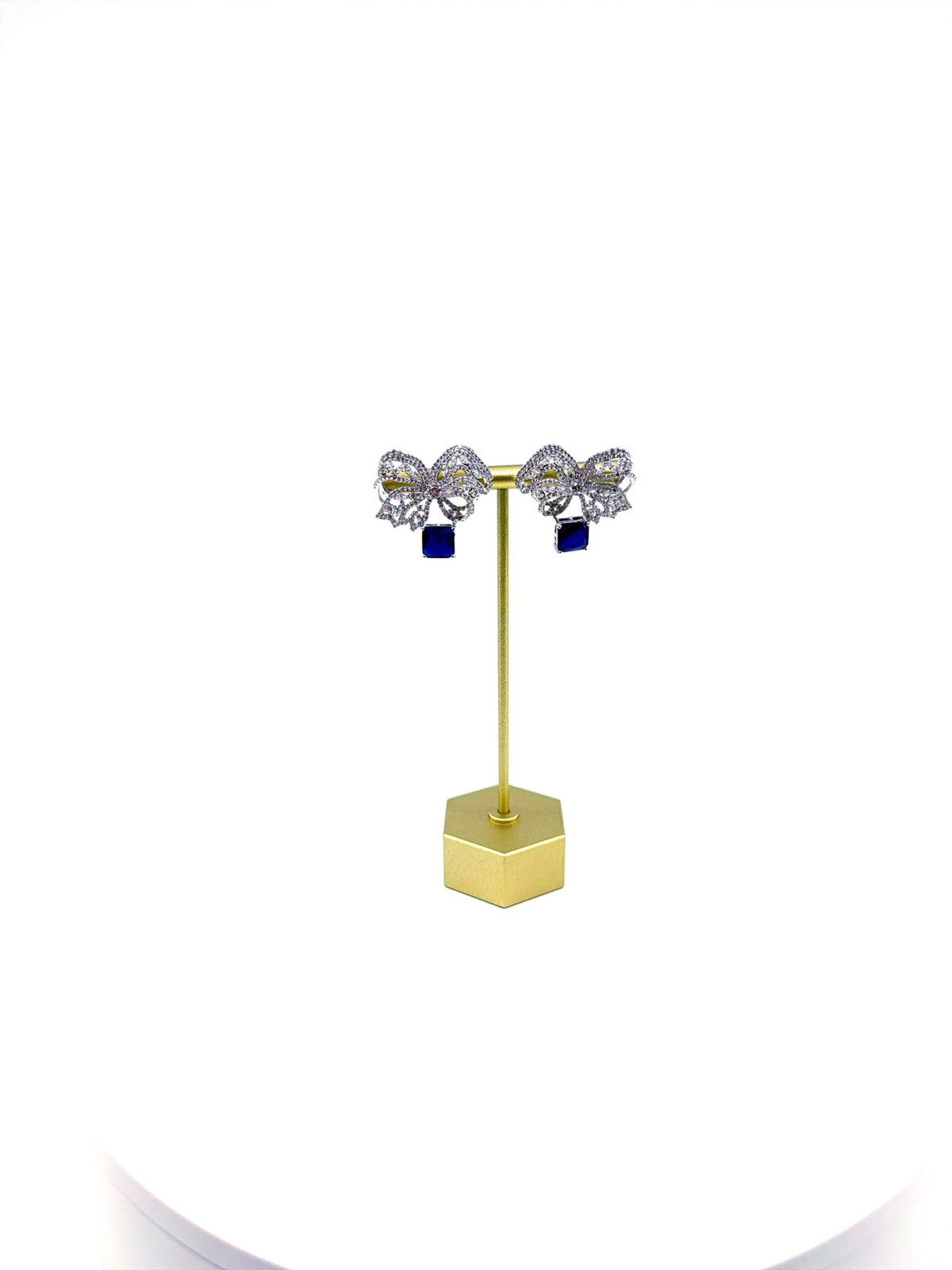 Sapphire blue pavé crystal bow drop earrings on a gold stand
