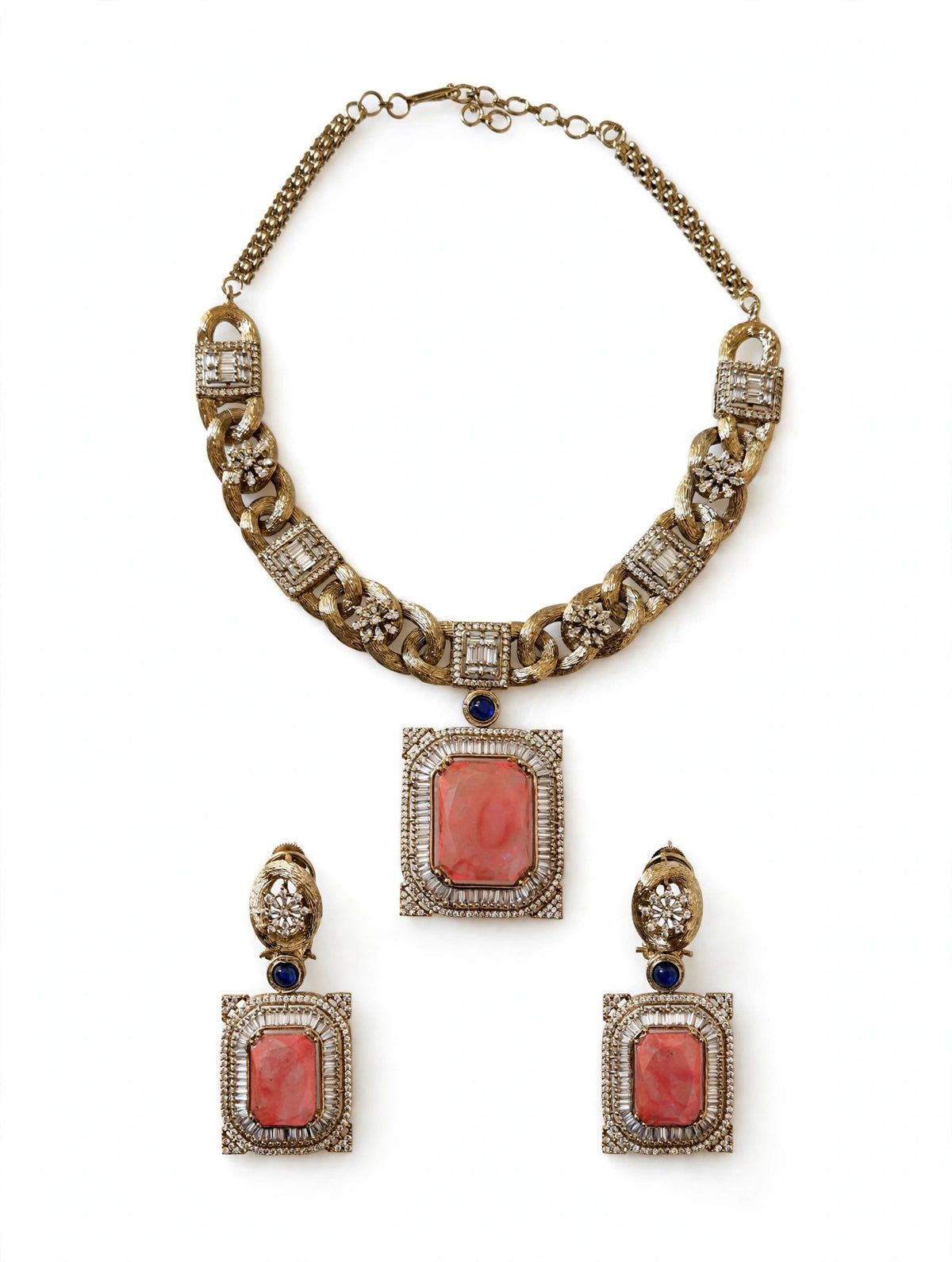 Coral pendant link necklace and matching earrings on a white background