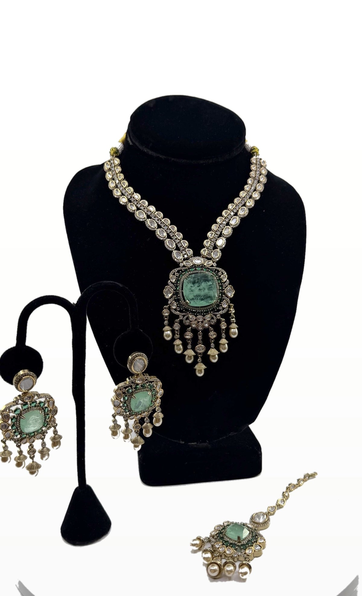 Mint Cushion Polki Bridal Set necklace, earrings and maang tikka on clean background